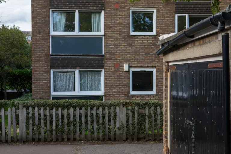 A block of terraced homes, with a garage in front