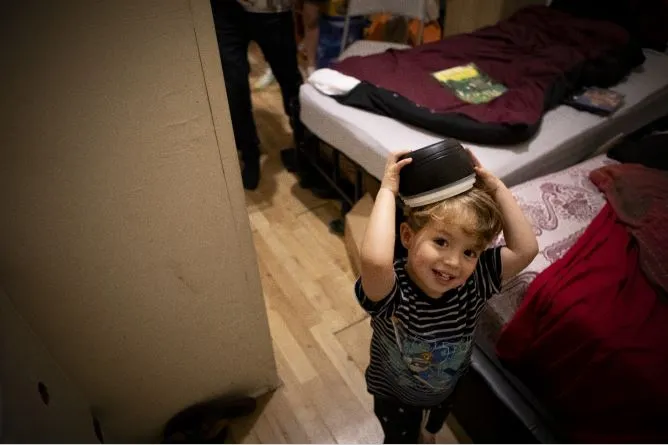 A toddler plays in a small room (temporary accommodation)