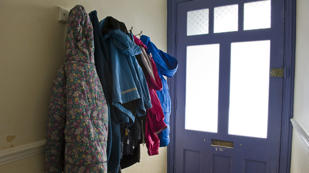 Image of coats hanging in the hallway of a home