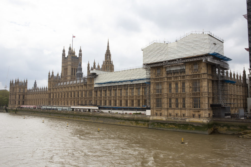 The Houses of Parliament are seen covered in scaffolding