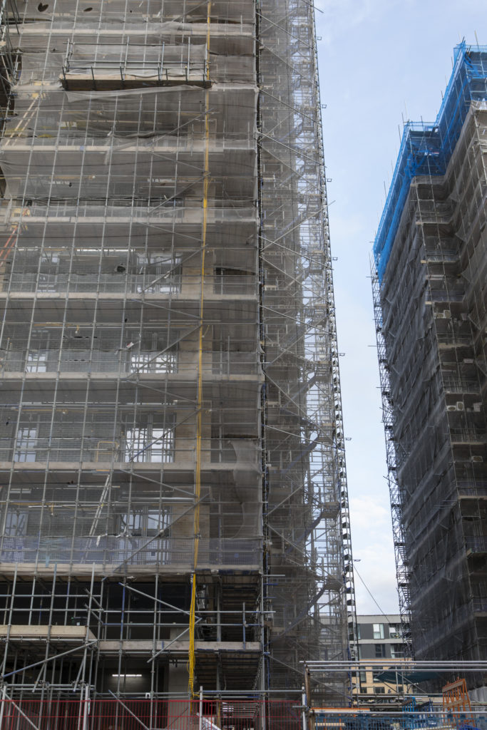 An image of scaffolding on a high rise building being built 