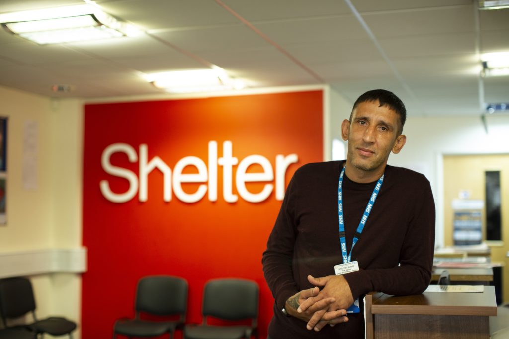 Paddy Burke, Shelter Peer Mentor, looking into the camera in the Shelter office 