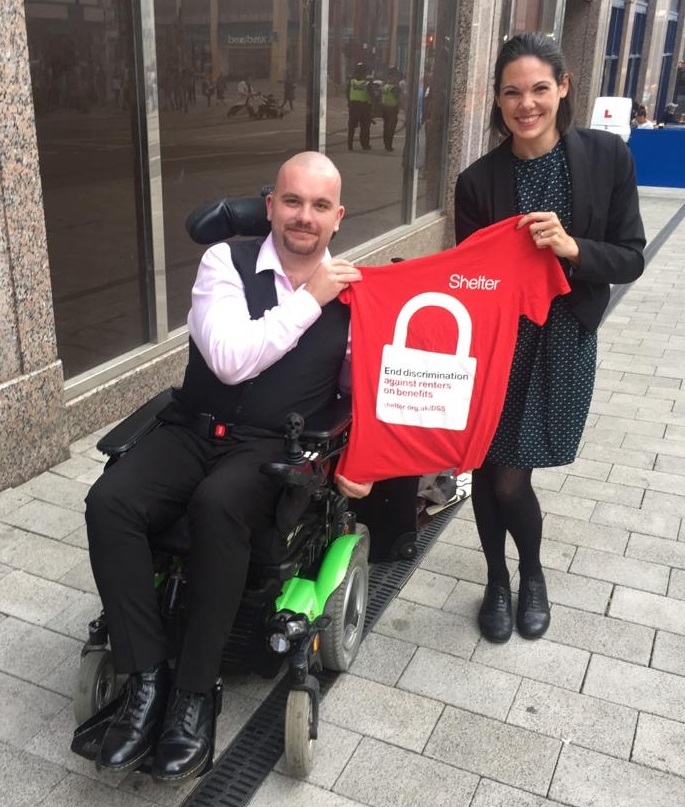A man in a wheelchair and a solicitor standing outside the court