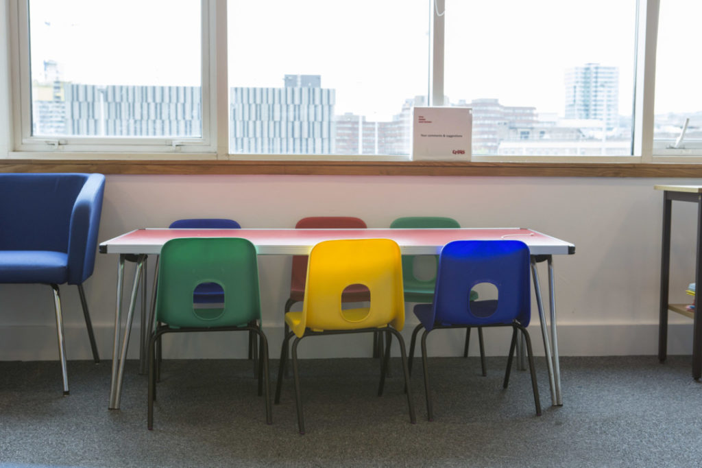 A table and a row of empty chairs in Shelter's Sheffield Hub