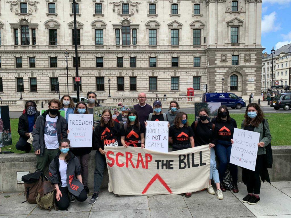 Shelter activists at a protest with a banner saying 'scrap the bill'