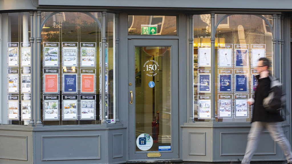A man walks past a letting agents' window