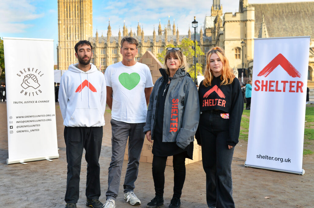 Four people standing in a line with the Houses of Parliament in the background