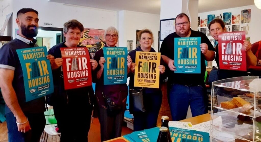 A group of campaigners in Birmingham holding Birmingham Fair Housing Campaign posters