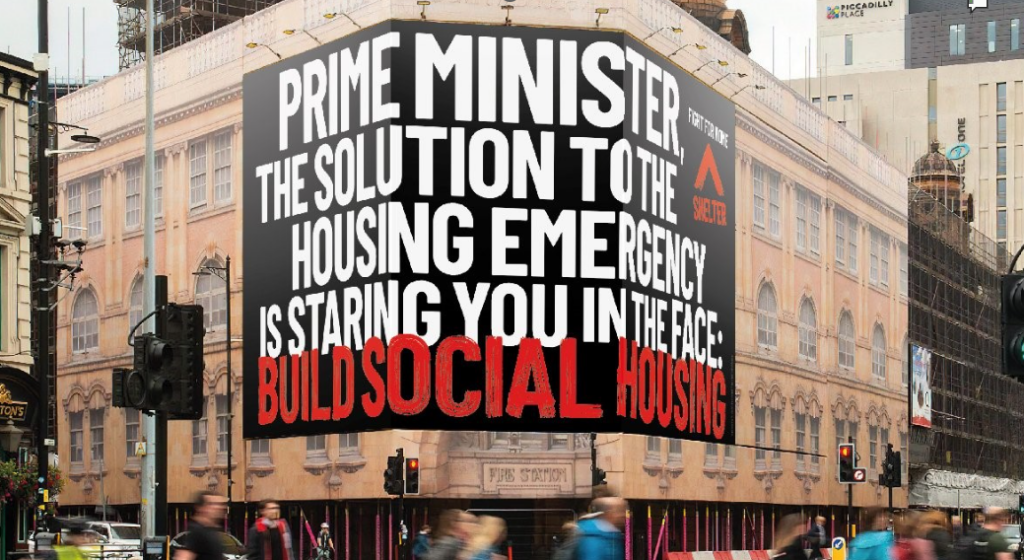 A Shelter banner suspended across a building near Westminster that reads: Prime Minister, the solution to the housing emergency is staring you in the face: Build social housing.